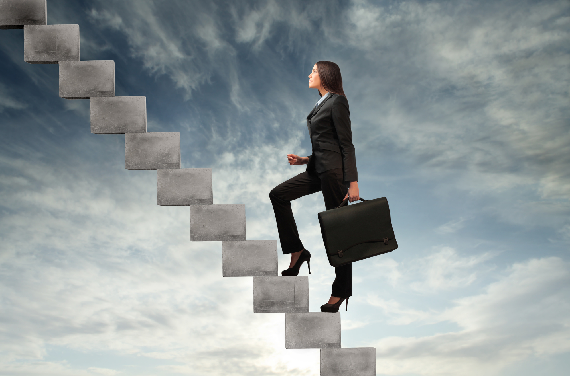 photo of women in business attire climbing steps in the sky