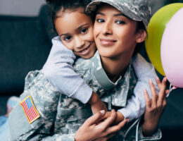 female veteran mom with her daughter at home celebrating