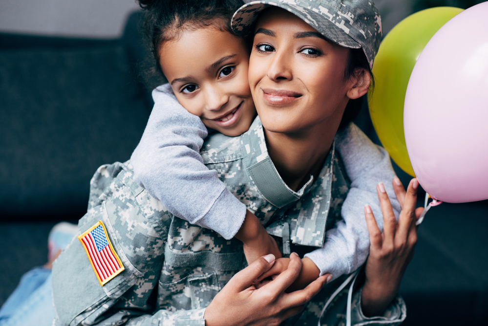 female veteran mom with her daughter at home celebrating